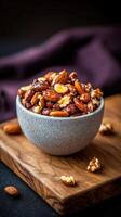 Delicious assortment of roasted nuts presented in a rustic bowl on a wooden board in a cozy setting photo