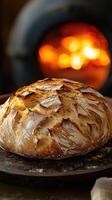 Freshly baked artisan bread with rustic crust in front of an open flame oven photo