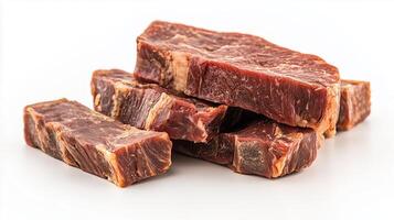 Sliced dried beef jerky stacked on white background photo