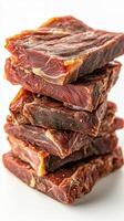 Stacked pieces of jerky on a white background showcasing rich texture and savory flavor photo