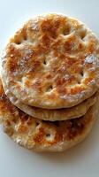 Freshly baked flatbread stacked on white background photo