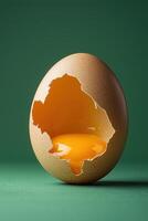 Creative eggshell concept with cut-out map shape and liquid inside on green background photo