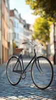 Stylish blue bicycle parked on a cobblestone street with blurred historic buildings in the background photo