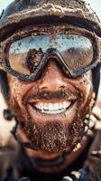 Close-up portrait of a smiling soldier covered in dirt and mud while wearing sunglasses photo