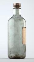 Vintage grey glass bottle with metal cap and label on white background photo