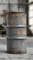 Rusty blue metal barrel with chips and scratches in urban setting photo