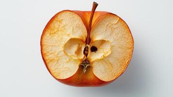 Cross-section of a fresh red apple revealing its core and seeds on a light background photo