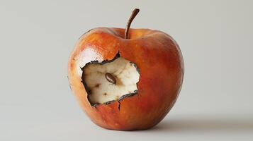 Cracked red apple with exposed interior and seed highlighting decay photo