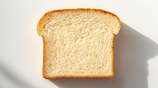 Freshly sliced white bread with soft texture and light shadows photo
