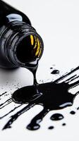 Spilled black ink from a bottle creating a glossy abstract background photo