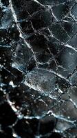 Close-up of shattered glass with intricate patterns and reflections photo