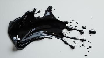 Liquid black paint splash with droplets on a gray background photo