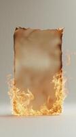 Burning piece of paper with flames engulfing edges on white background photo