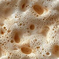 Close-up of coffee foam texture with different sizes of bubbles and creamy patterns photo