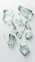 Shattered glass fragments on white surface creating an abstract composition photo