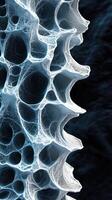 Intricate microstructure displaying fluid-like patterns in blue and white on a dark background photo