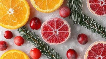 Frozen citrus and cranberries with pine branches on white background photo