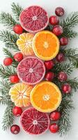 Colorful slices of frosted citrus fruits and cranberries with evergreen sprigs for holiday decor photo
