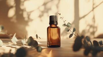 Amber glass bottle surrounded by eucalyptus leaves in warm sunlight photo