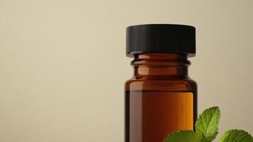 Brown glass bottle with black cap and green mint leaves on beige background photo