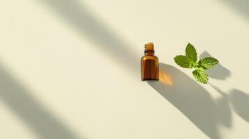 Minimalist brown glass bottle with green leaves on beige background for natural skincare concept photo