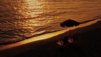 Serene sunset beach with chairs and umbrella reflecting golden light photo