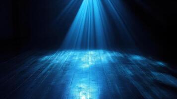 Dramatic blue spotlight illuminating a dark wooden floor in a mysterious setting photo