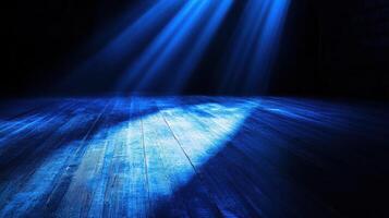 Mysterious blue spotlight on wooden stage in dark empty theater atmosphere photo