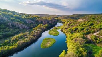 Aerial perspective of river meandering through verdant valley landscape photo