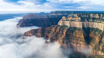 Majestic aerial view of canyon with clouds hovering over rugged cliffs photo