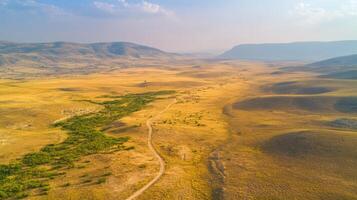 Aerial view of vast arid plain in mountainous desert landscape at dusk photo