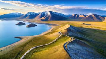 Majestic mountain landscape with serene lake and snow-capped peaks under blue sky photo