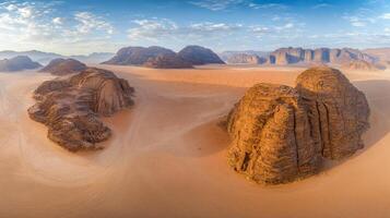 Aerial view of majestic desert landscape with sand dunes and rocky formations photo