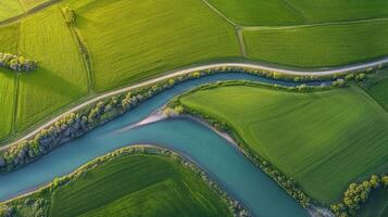 Aerial view of a meandering river through verdant countryside fields and landscapes photo