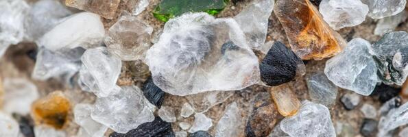 Close-up view of colorful sea glass pieces and pebbles on the beach sand photo