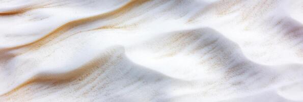 Aerial view of sand dunes with smooth patterns and gentle waves in desert landscape photo