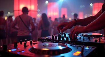 DJ mixing music at a lively party with vibrant lights and crowd photo