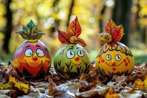Three painted eggs with faces on them in the leaves photo