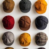 A variety of hats are arranged in a row photo