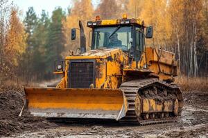 A bulldozer is driving through a muddy field photo