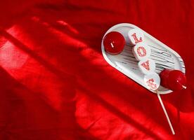 festive background for valentine's day candles on red background photo