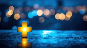 Glowing Yellow Cross on Wet Blue Surface with Bokeh Background Lights photo
