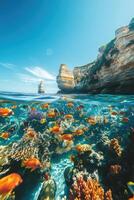 Ocean view with coral reef and many fishes swim under clear water near cliffs. Sunny weather, bright sky. photo