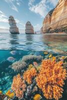 Ocean view with tall rocks and coral reef. Fish swim near bright coral under calm clear ocean. Underwater marine life scene. photo