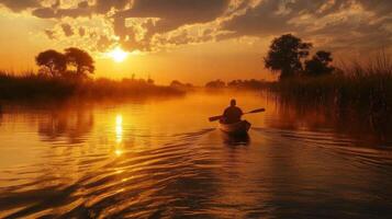 River at sunset. Person rows boat. Water reflects light. Calm water and nature. Peaceful mood with sun. Beautiful landscape image. photo