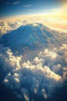 Snowy mountain rises above the clouds. The sun is shining brightly behind. Beautiful blue sky and cloudscape. Top view. photo