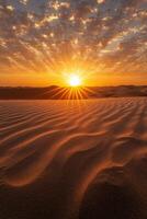 Desert sand dunes texture. Sunset over sand. Orange sky with clouds. Sun rays shine in the horizon. Desert landscape with abstract pattern. photo