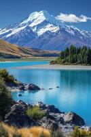Mountain peak view. Snow covered mountain at daytime. Lake and blue water. Trees and nature. Summer outdoors. photo