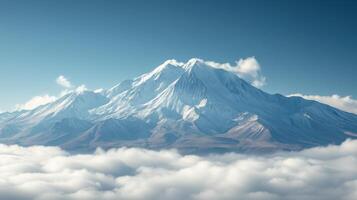 Snowy mountain peak rising above soft white clouds on a bright clear day. High altitude nature scenic view. photo