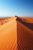 Sand dune under blue sky. Desert landscape view. Empty hot land. Golden sand texture in sunlight. Arid nature. Desert scenery background. photo